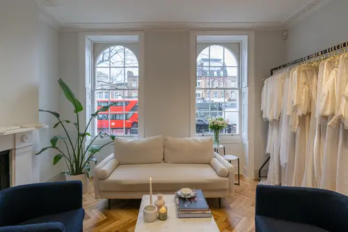 Office space at cornerstone studios showcasing couch and clothing rail.